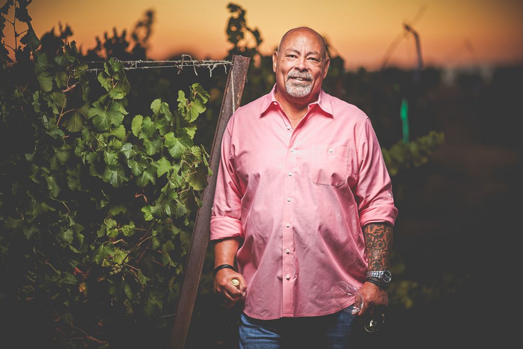 Phil Long of Longevity Wines, standing in the vineyard at dusk. 